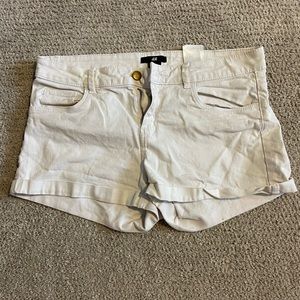 Loosely worn white H&M short shorts.